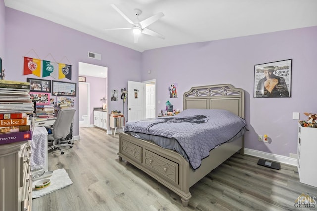 3105 Whisper Oak Way, Bakersfield, CA 93311 - bedroom featuring wood finished floors, a desk, baseboards, lofted ceiling, and connected bathroom