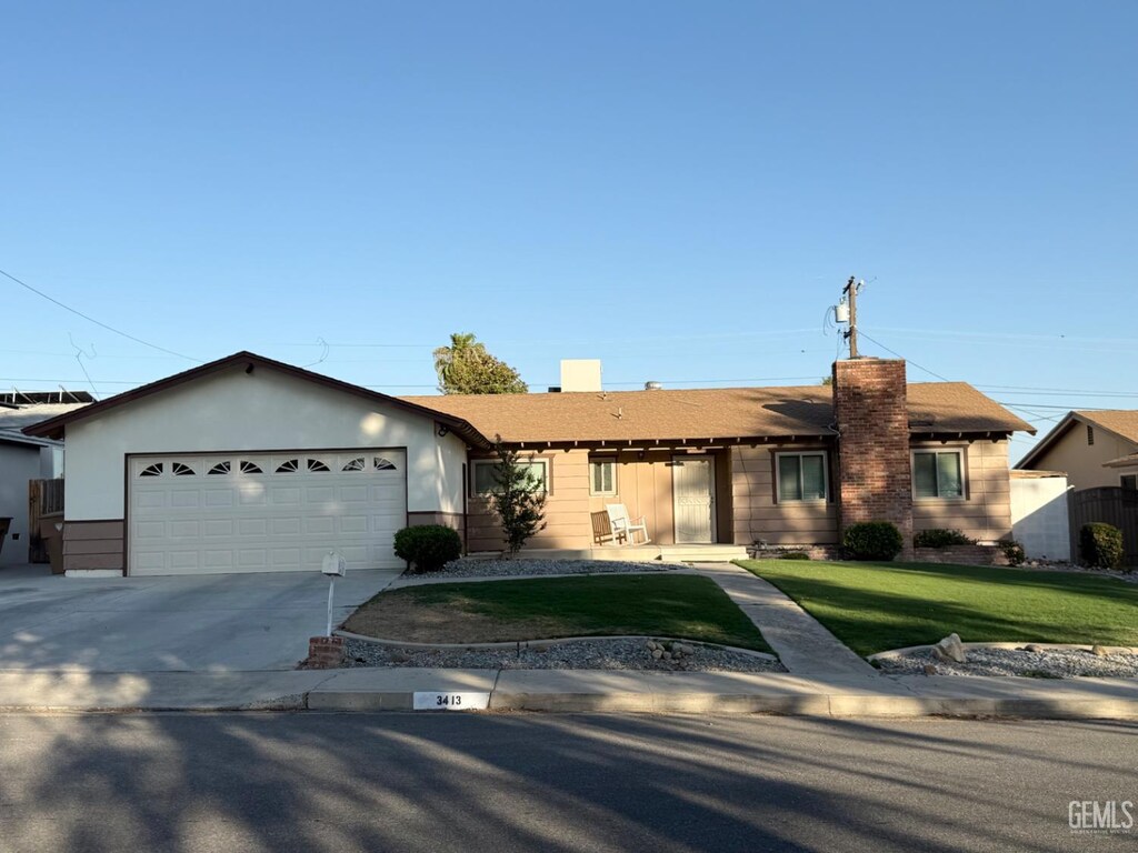 3413 Redlands Dr, Bakersfield, CA 93306 - ranch-style house featuring concrete driveway, a front yard, and a garage