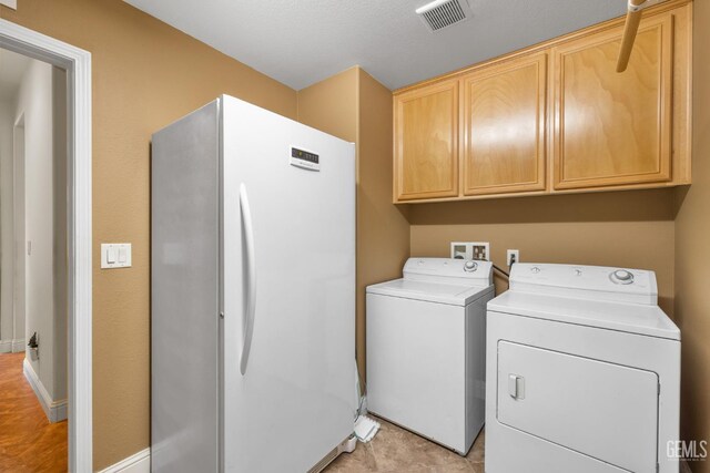 10114 Oporto Way, Bakersfield, CA 93306 - laundry area with cabinet space, washer and dryer, and baseboards