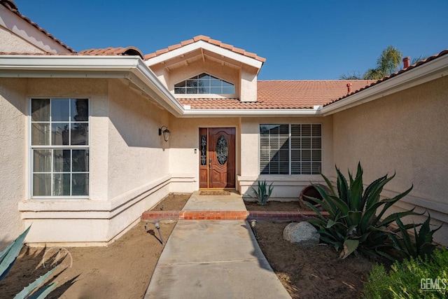 entrance to property featuring a patio