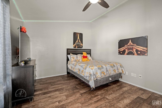 bedroom featuring crown molding, dark hardwood / wood-style floors, vaulted ceiling, and ceiling fan