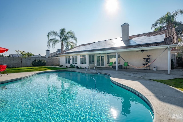 view of swimming pool with ceiling fan and a patio