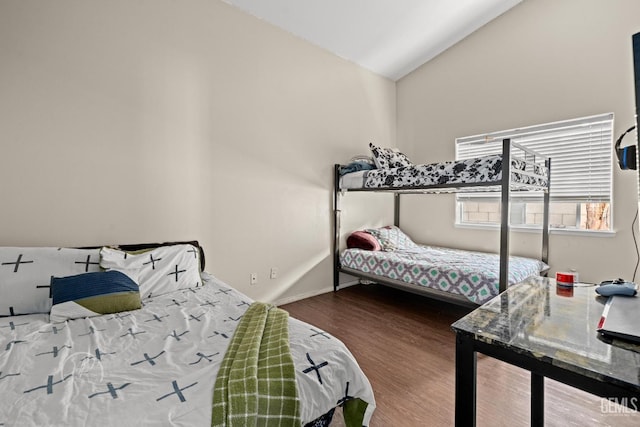 bedroom with wood-type flooring and lofted ceiling