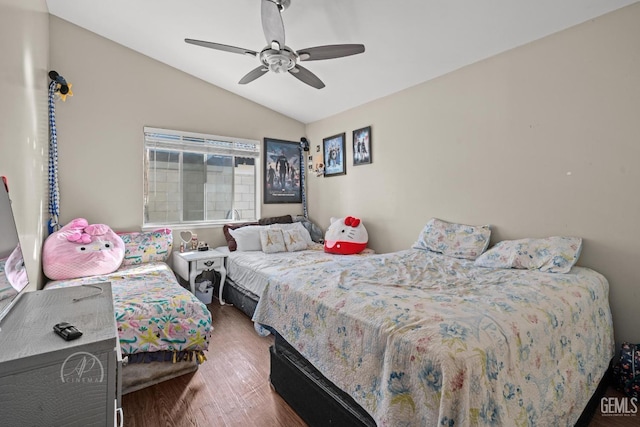 bedroom featuring ceiling fan, hardwood / wood-style flooring, and lofted ceiling