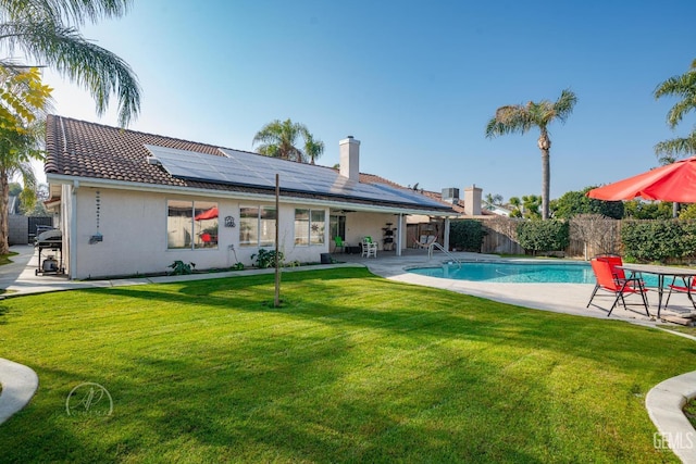 view of pool featuring a patio area and a lawn