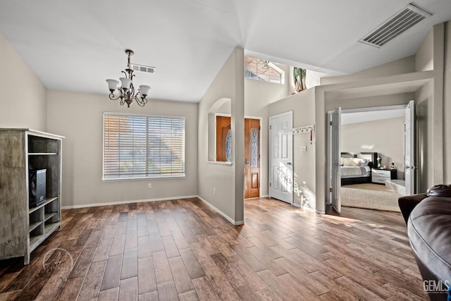 foyer featuring a notable chandelier and vaulted ceiling