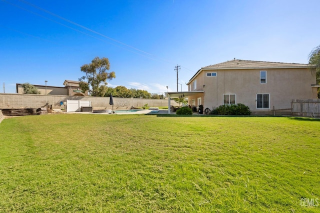 view of yard with a fenced in pool