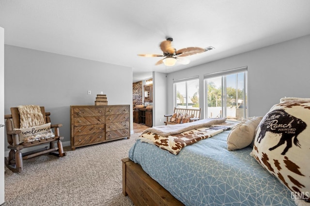 carpeted bedroom featuring ceiling fan and ensuite bath