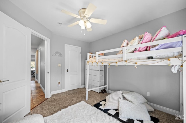 bedroom featuring ceiling fan and carpet