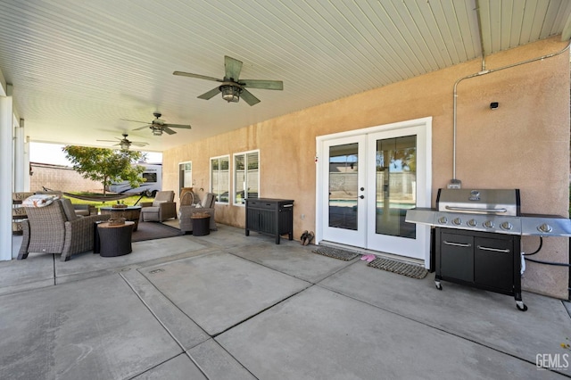 view of patio featuring ceiling fan, area for grilling, and french doors