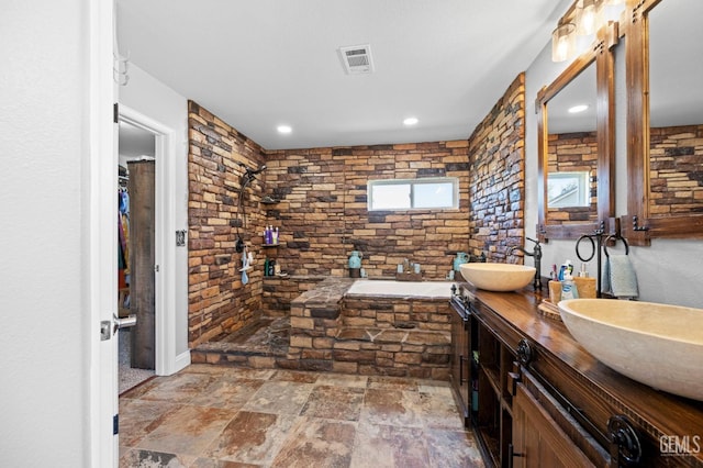 bathroom with a bathing tub and vanity