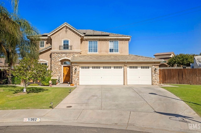 view of front property with a garage, a front yard, and solar panels