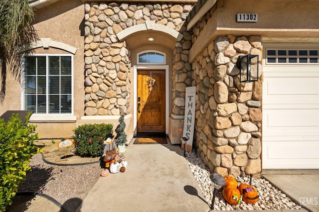 view of exterior entry featuring a garage