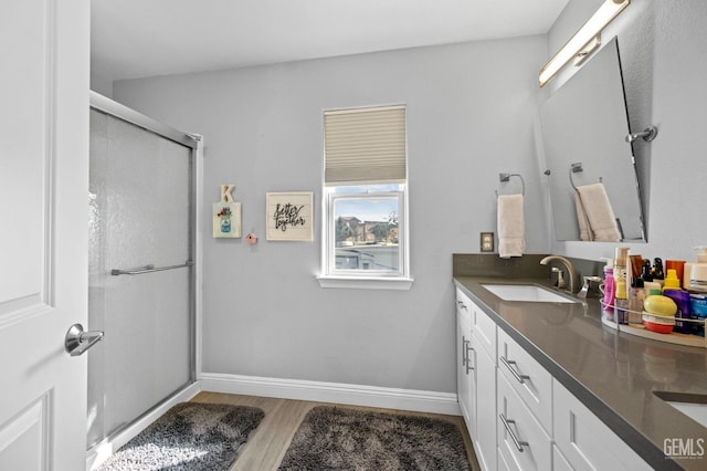 bathroom featuring vanity, walk in shower, and hardwood / wood-style floors