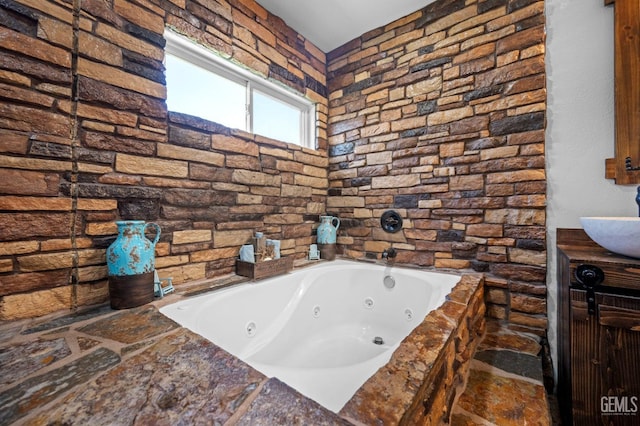 bathroom with sink and tiled tub