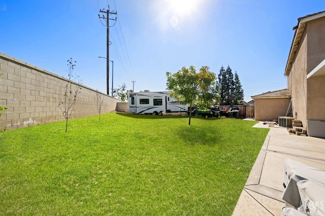 view of yard featuring cooling unit and a patio