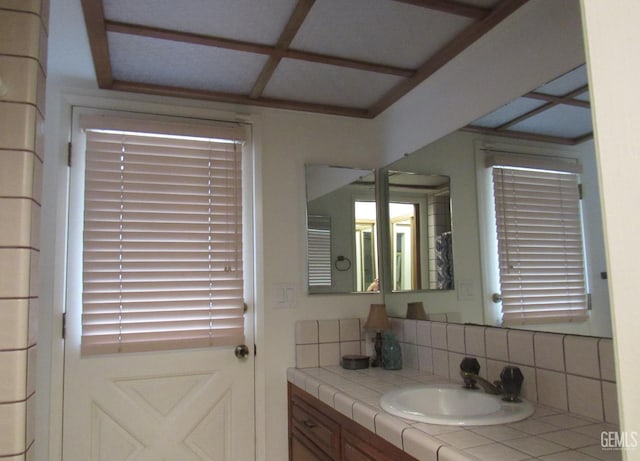 bathroom with vanity and backsplash