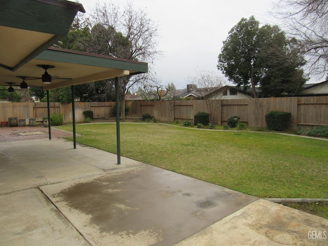 view of yard featuring ceiling fan and a patio area