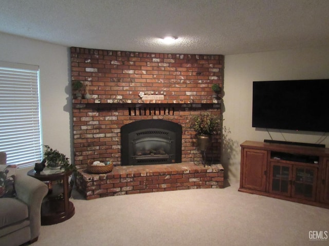 carpeted living room featuring a brick fireplace and a textured ceiling