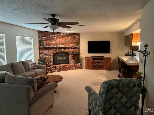 living room with a fireplace, light carpet, and a textured ceiling