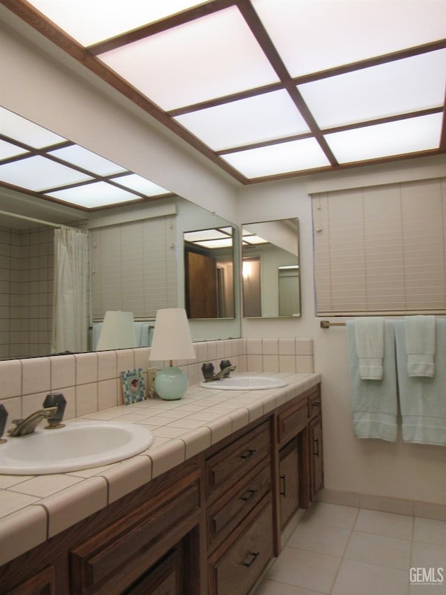 bathroom featuring vanity, backsplash, and tile patterned flooring