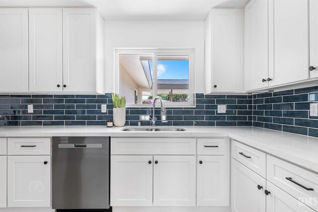 3700 Christmas Tree Ln, Bakersfield, CA 93306 - kitchen with stainless steel dishwasher, white cabinetry, light countertops, and decorative backsplash