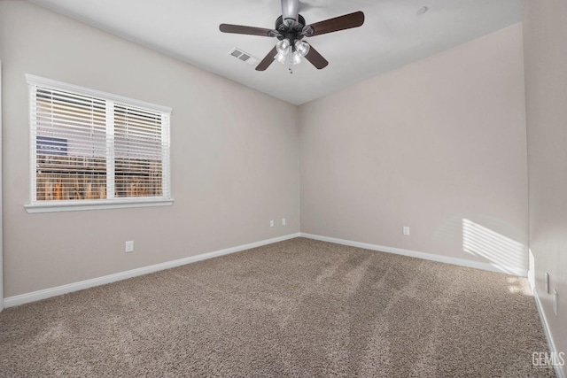 unfurnished room with ceiling fan and carpet flooring