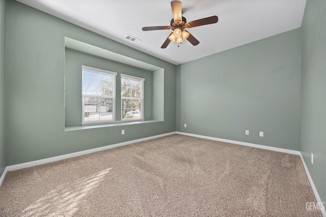 carpeted empty room featuring ceiling fan