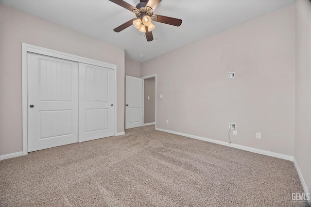 unfurnished bedroom featuring ceiling fan, a closet, and carpet flooring