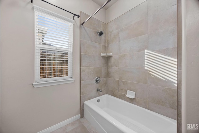 bathroom with tiled shower / bath combo and tile patterned flooring