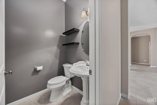 bathroom featuring toilet and tile patterned floors