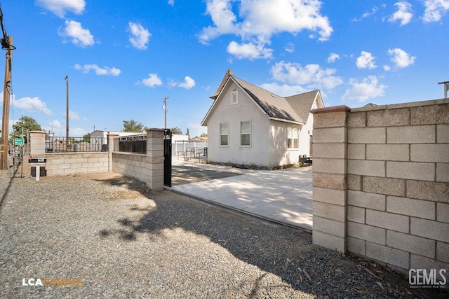 4620 Taft Hwy, Bakersfield, CA 93313 - view of side of home with stucco siding and a gate