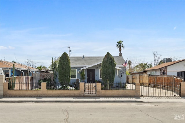 view of front of property featuring a gate, a fenced front yard, central AC, and a residential view