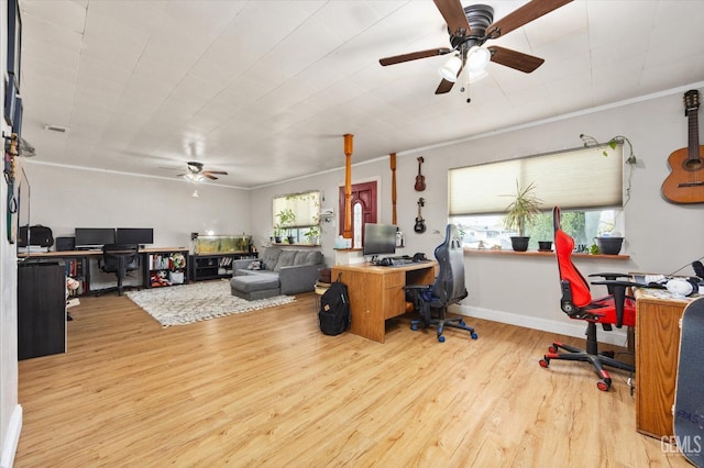 office featuring baseboards, crown molding, wood finished floors, and a ceiling fan