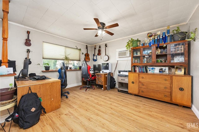 office with crown molding, light wood finished floors, baseboards, ceiling fan, and an AC wall unit