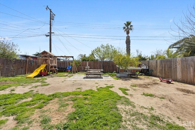 view of yard featuring a fenced backyard and a playground