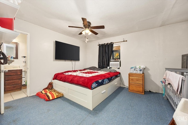 carpeted bedroom with cooling unit, a ceiling fan, and ensuite bath