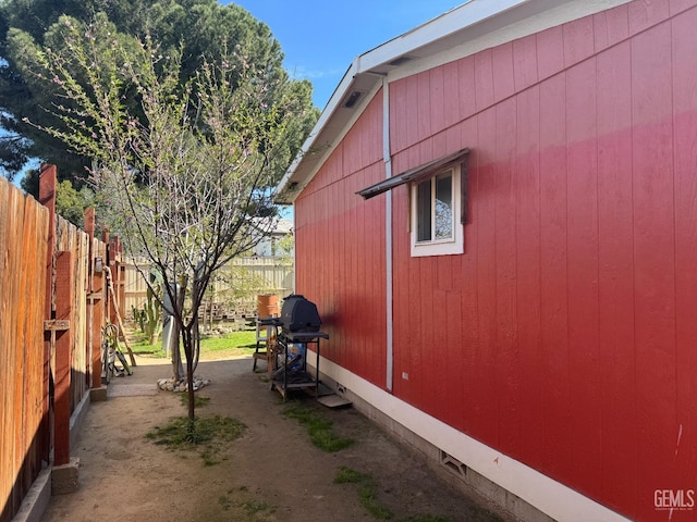 view of side of property featuring fence