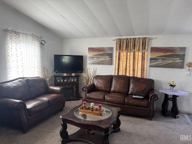 carpeted living area with vaulted ceiling and a textured ceiling