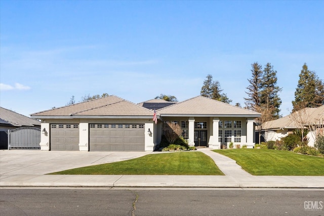 view of front of property with a garage and a front lawn