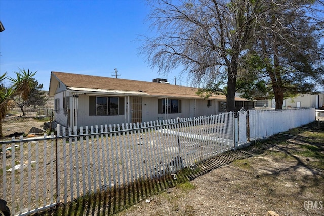 ranch-style house featuring a fenced front yard