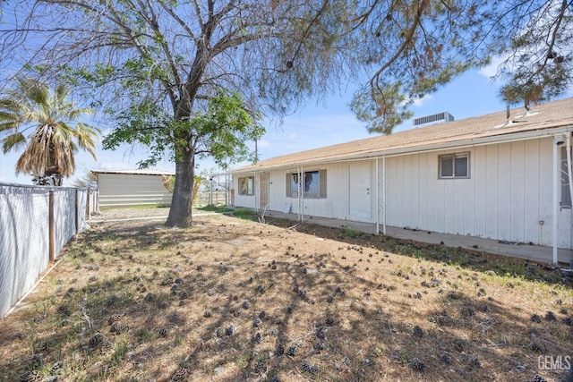 back of property featuring fence