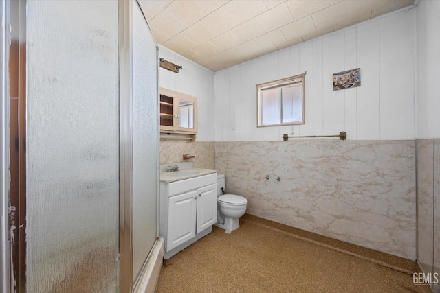 full bath with toilet, a stall shower, and vanity