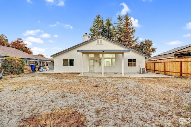 back of property featuring central air condition unit and a patio area