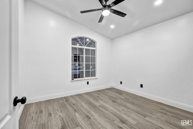 unfurnished room with vaulted ceiling, hardwood / wood-style floors, and ceiling fan