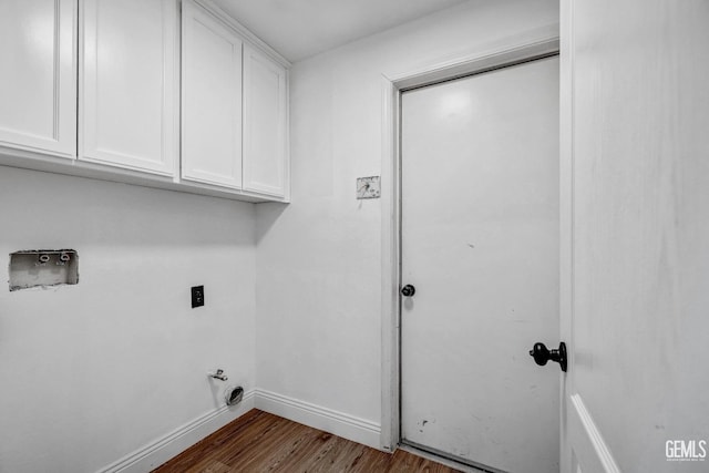 laundry room featuring dark wood-type flooring, cabinets, washer hookup, and hookup for an electric dryer