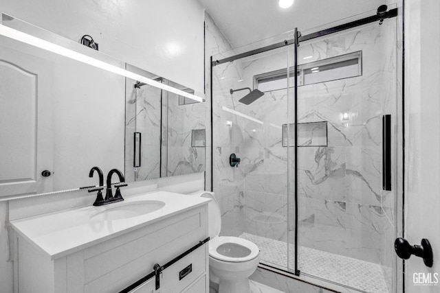 bathroom with vanity, toilet, and walk in shower