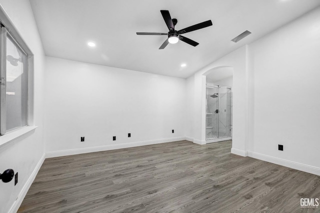 unfurnished room featuring dark wood-type flooring and ceiling fan