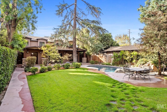 view of yard with a fenced in pool and a patio