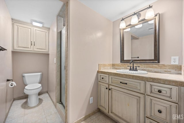 bathroom featuring tile patterned floors, vanity, toilet, and a shower with door